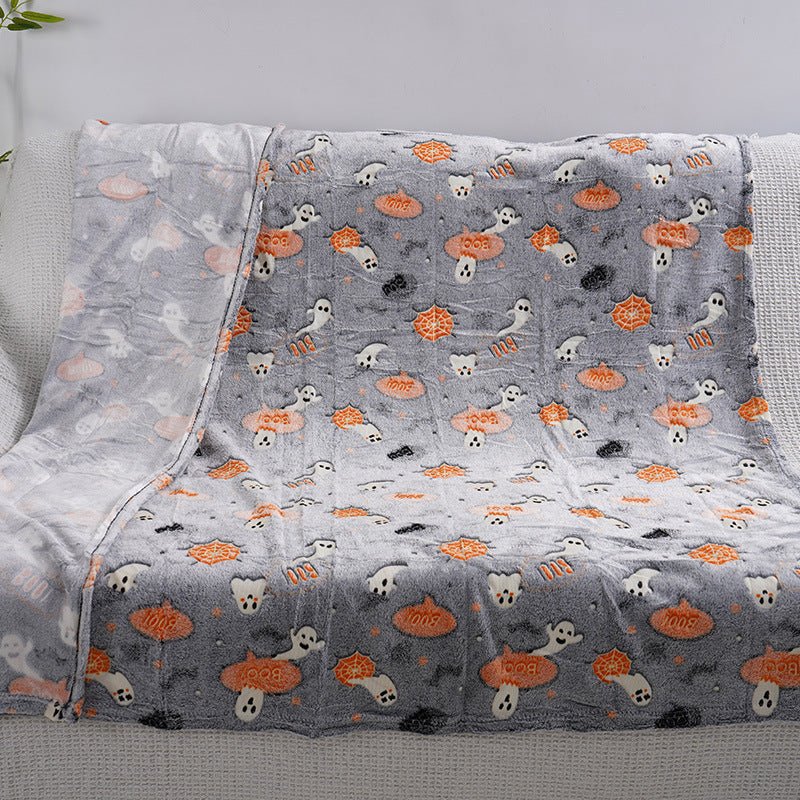 Flat view of Halloween glow blanket with pumpkin, ghost, bat glow motifs