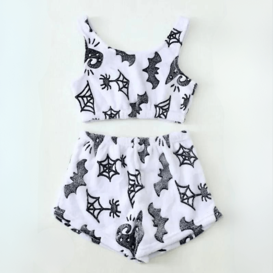 Flat lay of halloween white spiderweb sherpa pajama set with crop top and shorts on white background