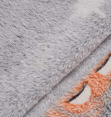Zoomed view of gray glowing ghost and pumpkin print on plush Halloween fabric