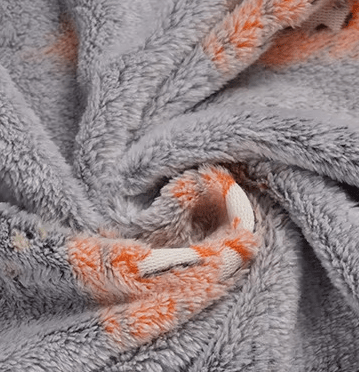 Swirl texture detail of glow-in-the-dark blanket showing dual-sided plush fabric