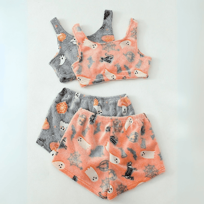 Flat lay of pink and grey sherpa pajama sets side by side on white background