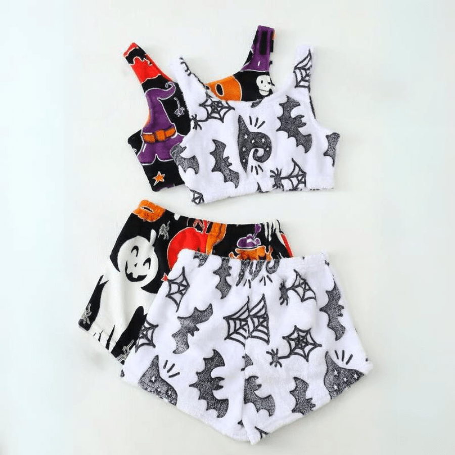Flat lay of two sherpa pajama sets in black and white prints with bats and pumpkins