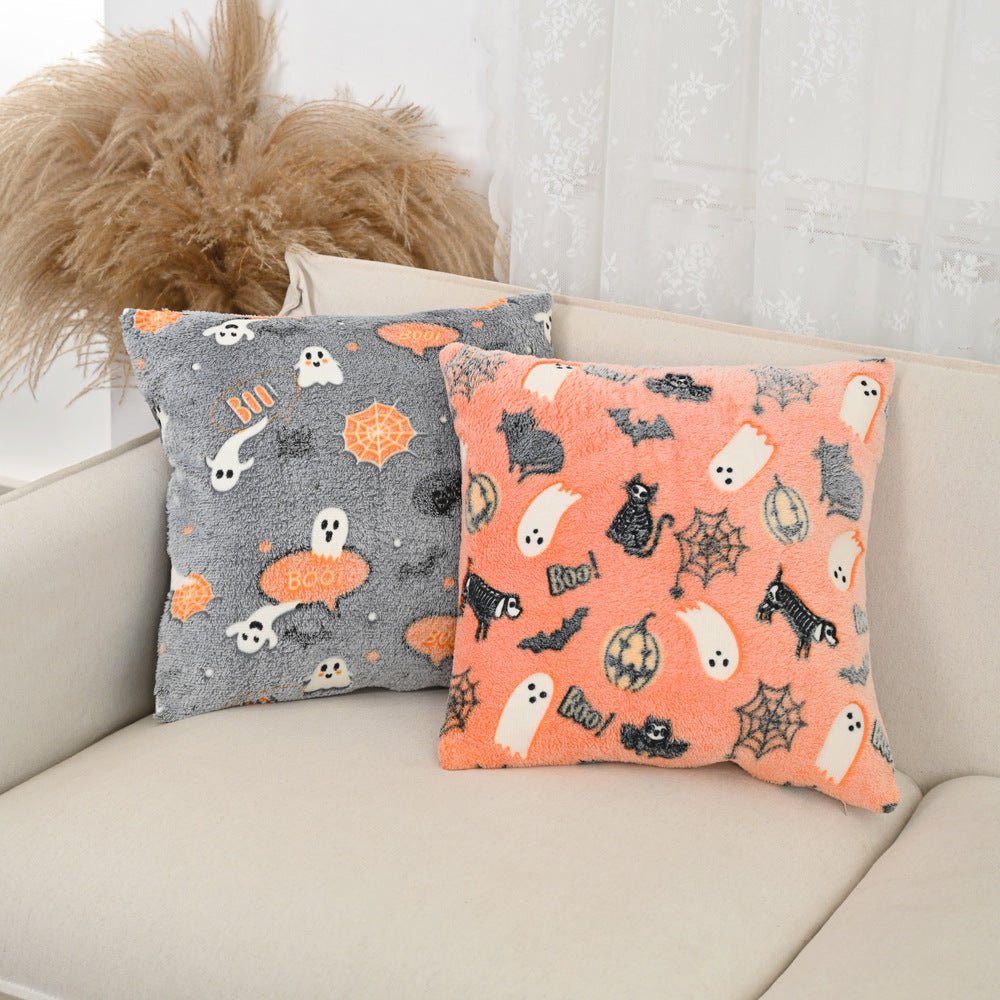 Decorative Halloween pillow featuring ghost, spiderweb, and bat glow motifs
